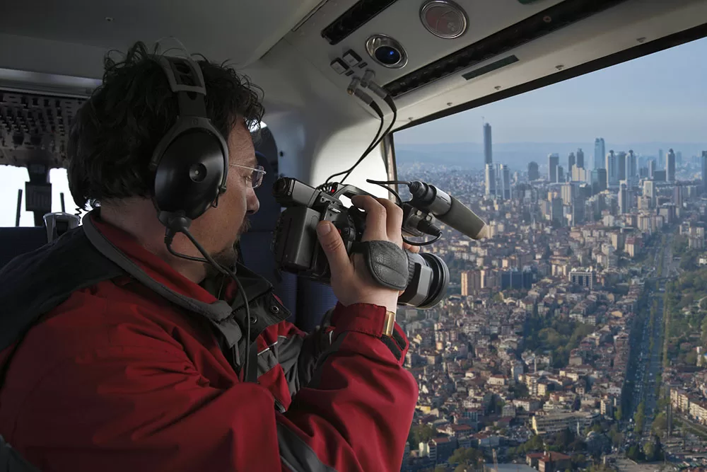 Cameraman shooting video in the helicopter