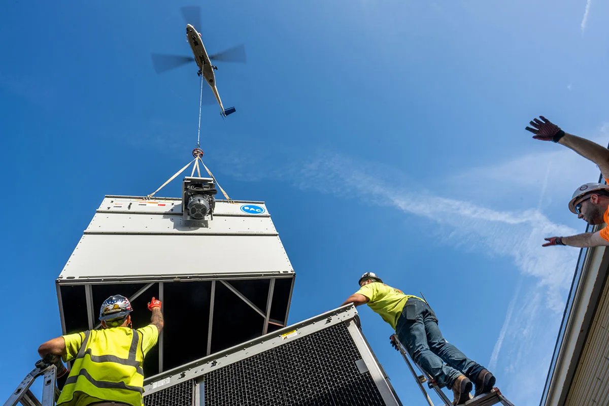 Heavy Lift Helicopter installing commercial HVAC RTU