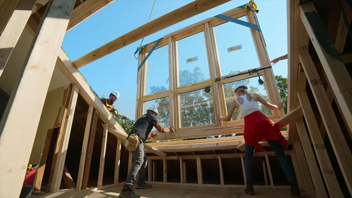 Carefully placing the skylight on to the roof.