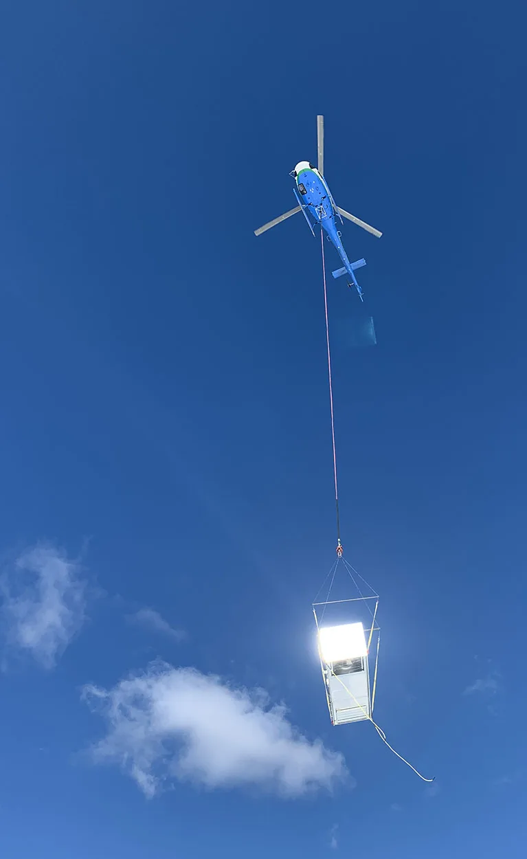 The Airbus H125 in the air with a gleaming HVAC RTU.