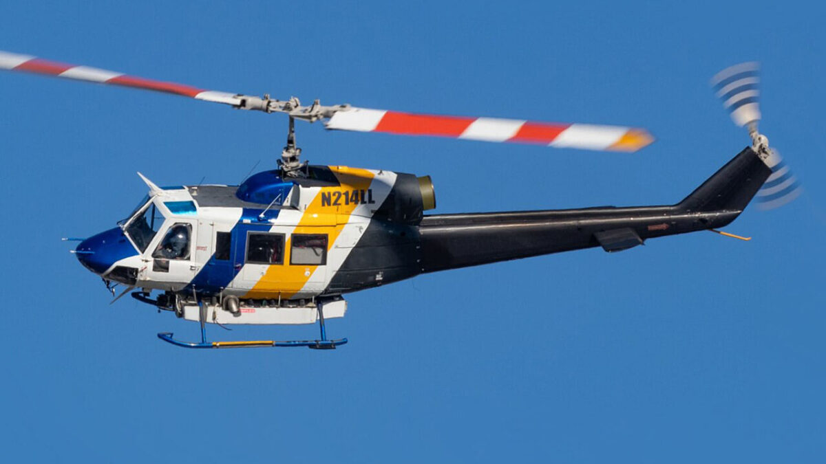 Bell 214B Big Lifter helicopter in flight against a clear sky, demonstrating its impressive aviation capabilities and design.