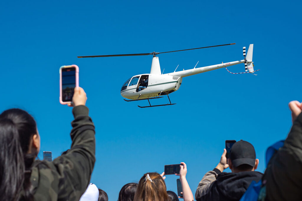Onlookers enjoy an Easter helicopter egg drop event