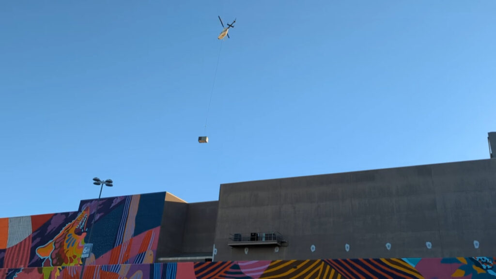 The Bell 206 Jet Ranger flying the HVAC over the roof of Park Place Mall, Tucson, AZ.
