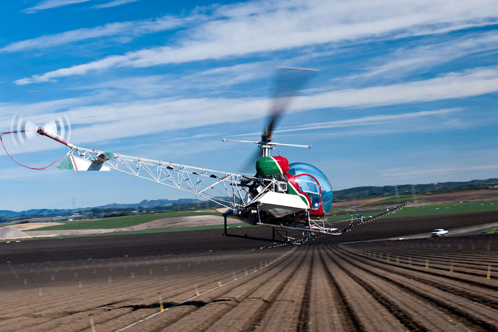 Helicopter flying low to begin pesticide spraying