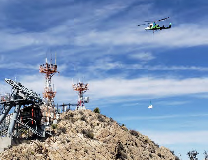 Kaman K-1200 "K-MAX" lifting construction materials utilizing the 'Super Sack'
