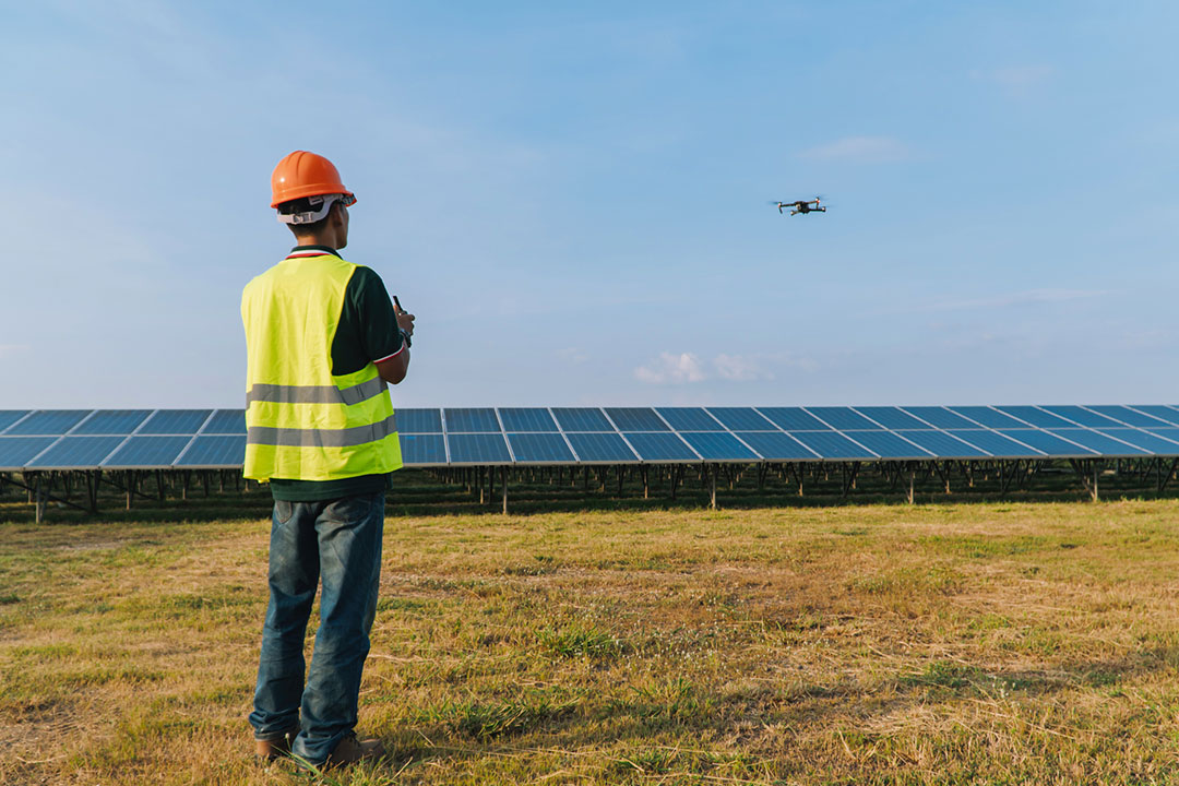 Engineer Flying Drone Over Solar Panels