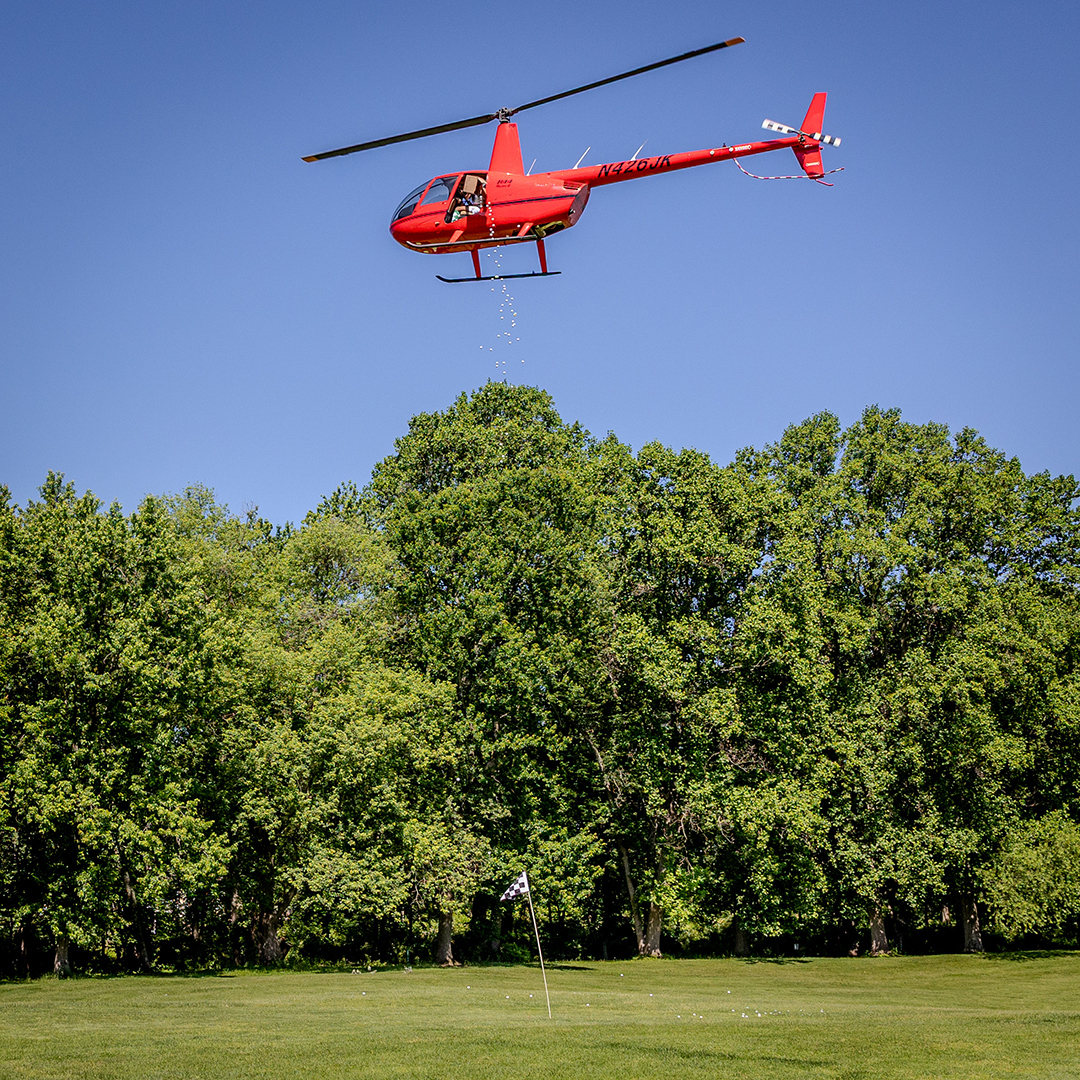 The Robinson R44 executes the golf ball drop. | Photo: Craig Hunter Ross
