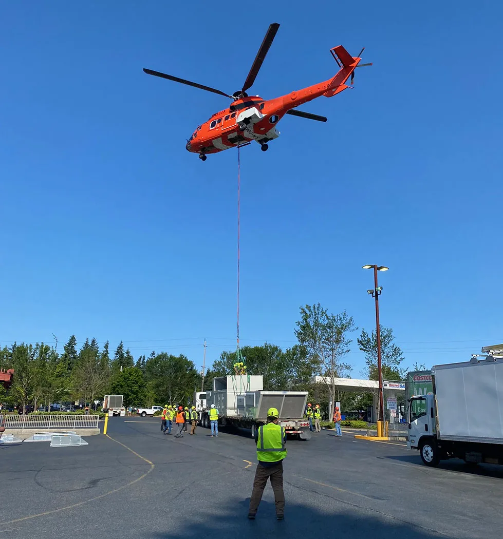 The AS332 Super Puma lifting a 8,148 Pound Rooftop RTU