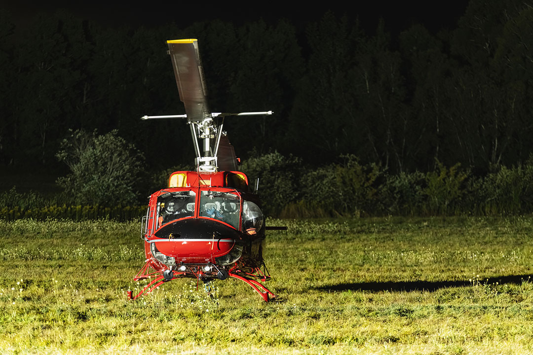 A firefighting helicopter sits at a landing area.