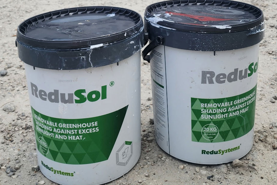 On the jobsite with 2 Buckets of ReduSol Greenhouse Shading Agent