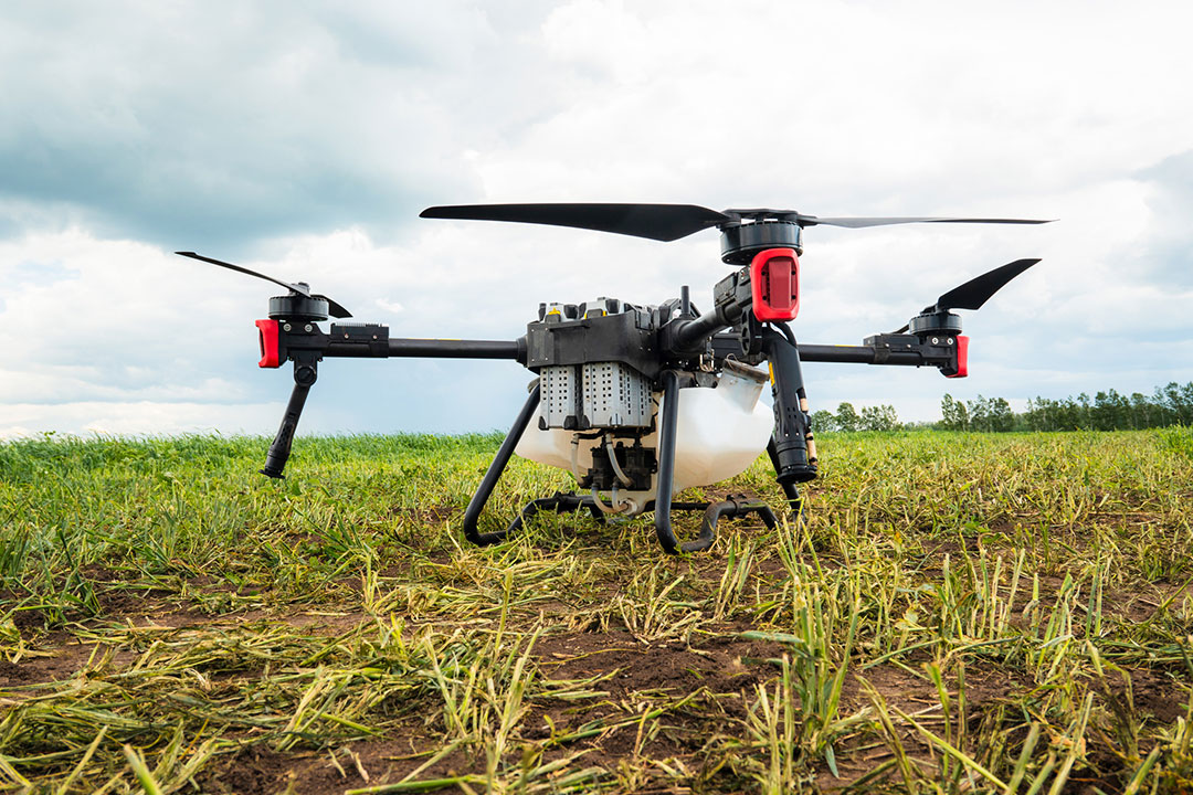 An agricultural drone sits at rest on a farm.