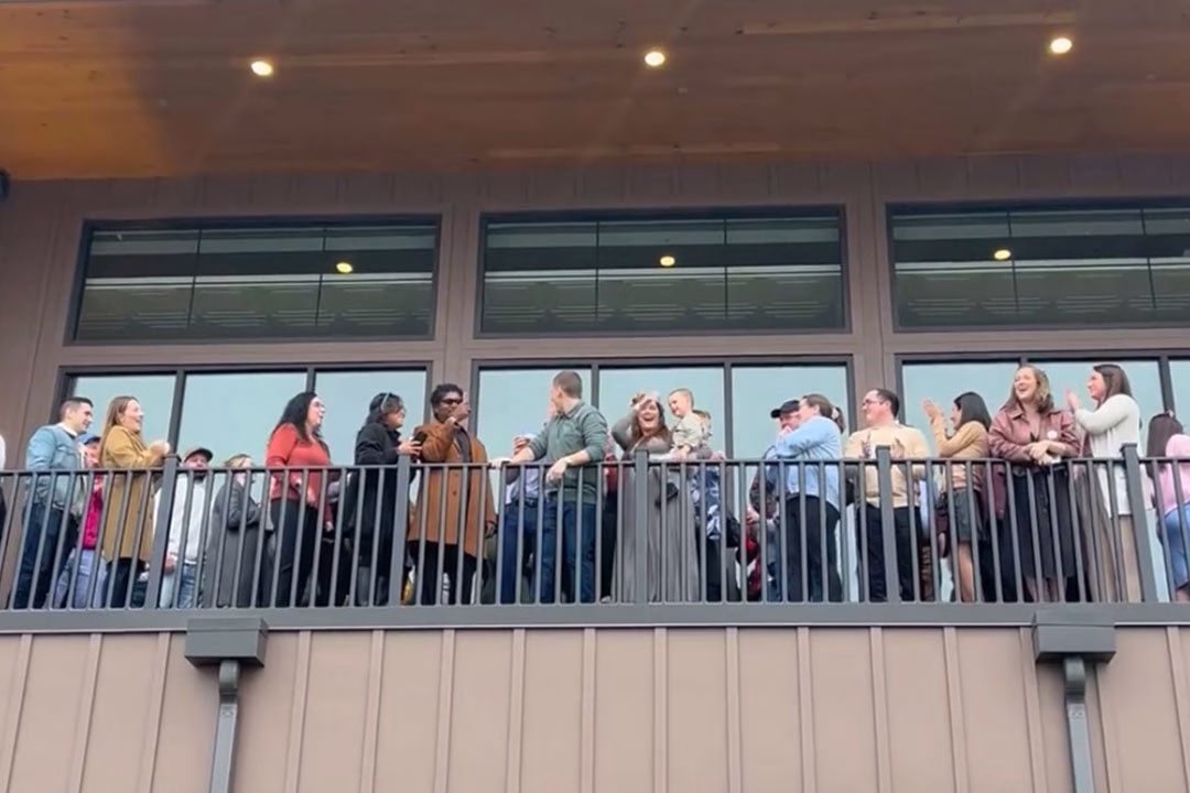 The Maass family and friends cheer on the gender reveal.