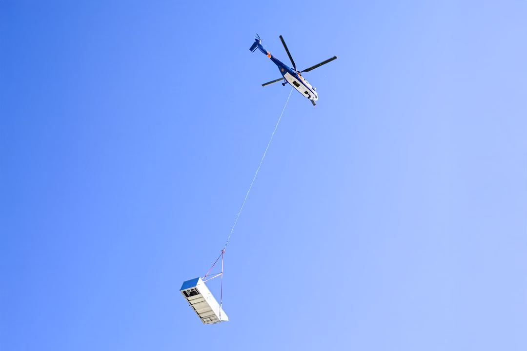 The SuperPuma lifting one of the large HVAC units.