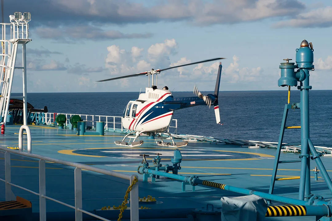 A crew transport helicopter sits at rest at an offshore operation.