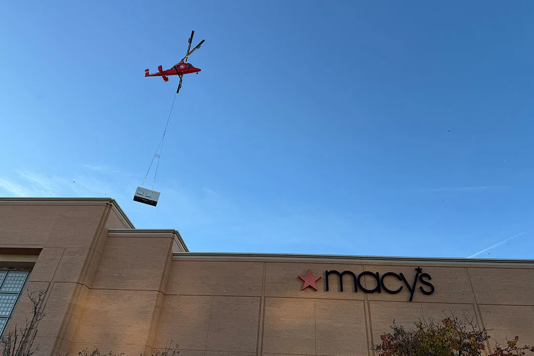 The K-MAX lifting the new HVAC unit to the roof of Macy's. 