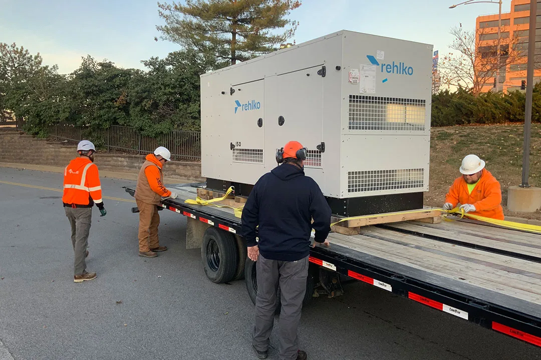The ground crew prepping the new generator in the staging area.
