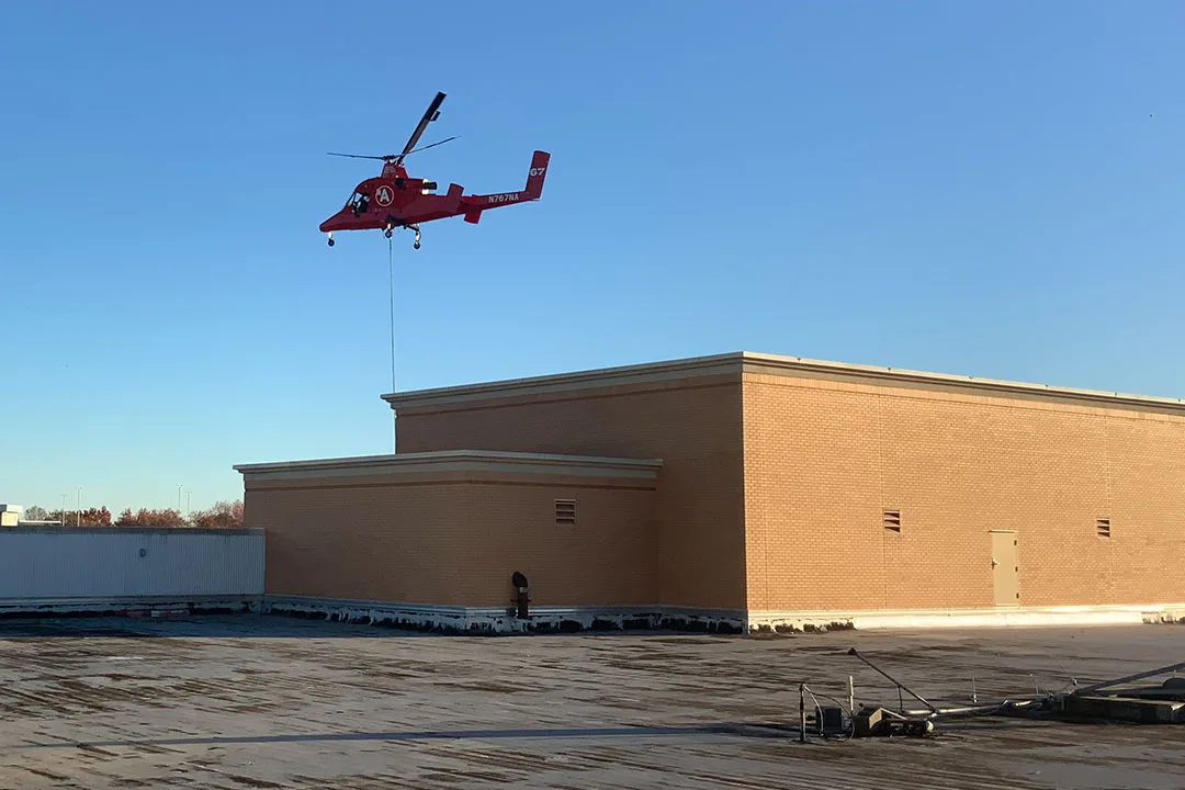 Kaman K-MAX hovers above the Macy's roof.