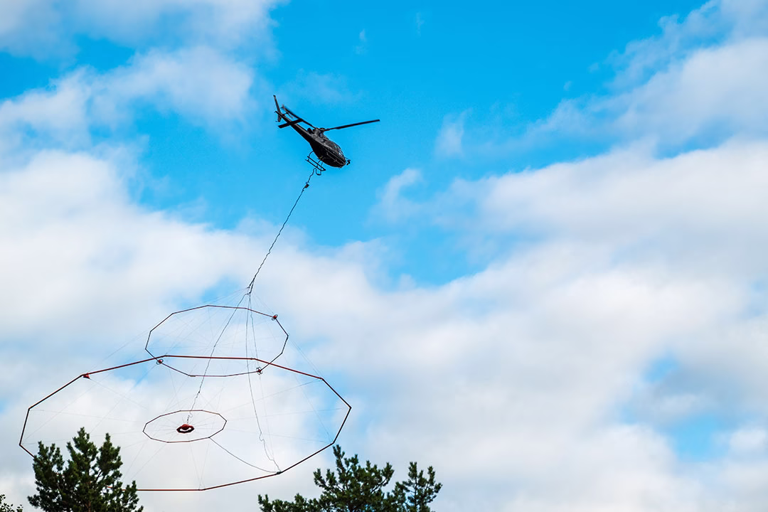 Helicopter with a special instrument searches for minerals from the air.