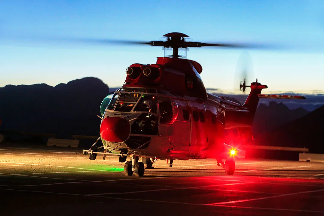 A helicopter staged on a tarmac prior to night operations.