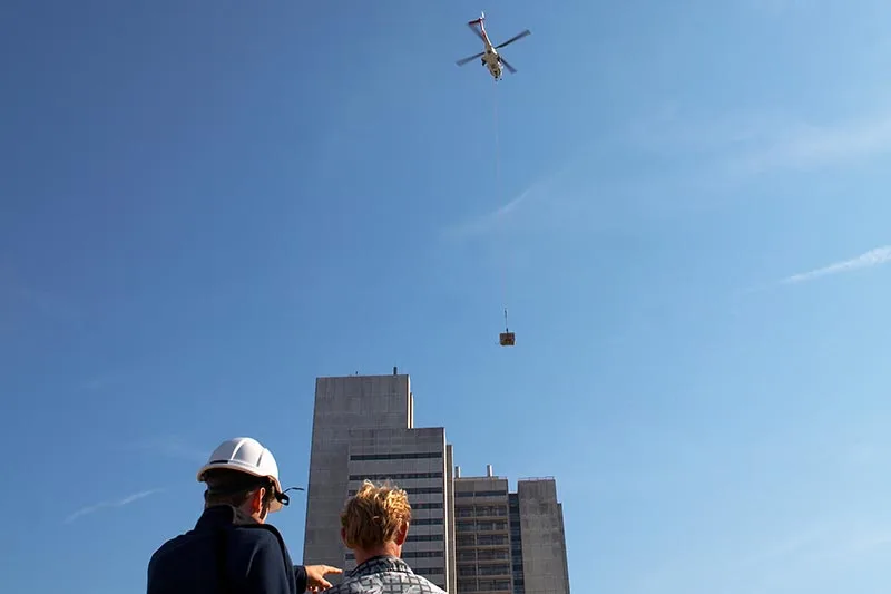 While a helicopter carries a higher hourly rate, completing multiple rooftop picks in a single morning often lowers the total project cost.