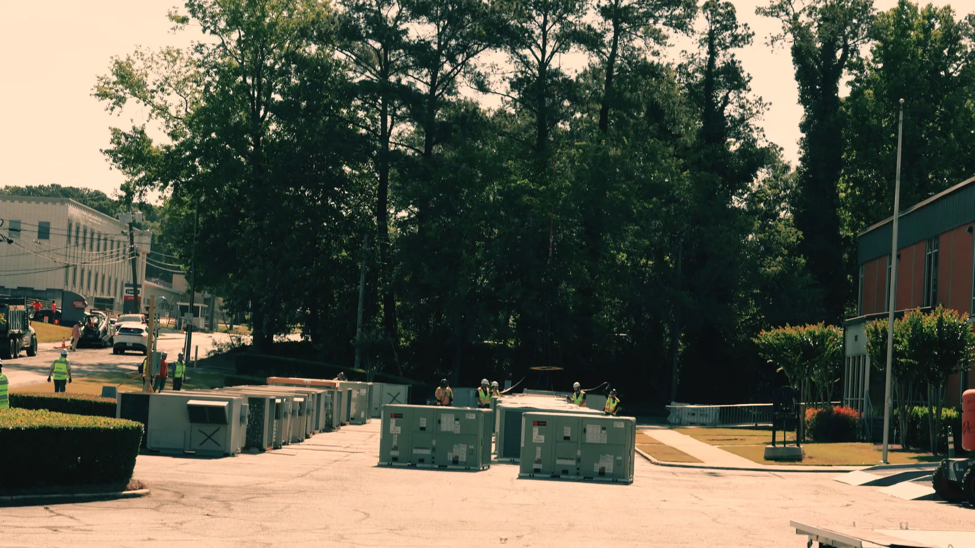 Commercial HVAC units lined up in an Atlanta parking lot staging area for a helicopter lift.