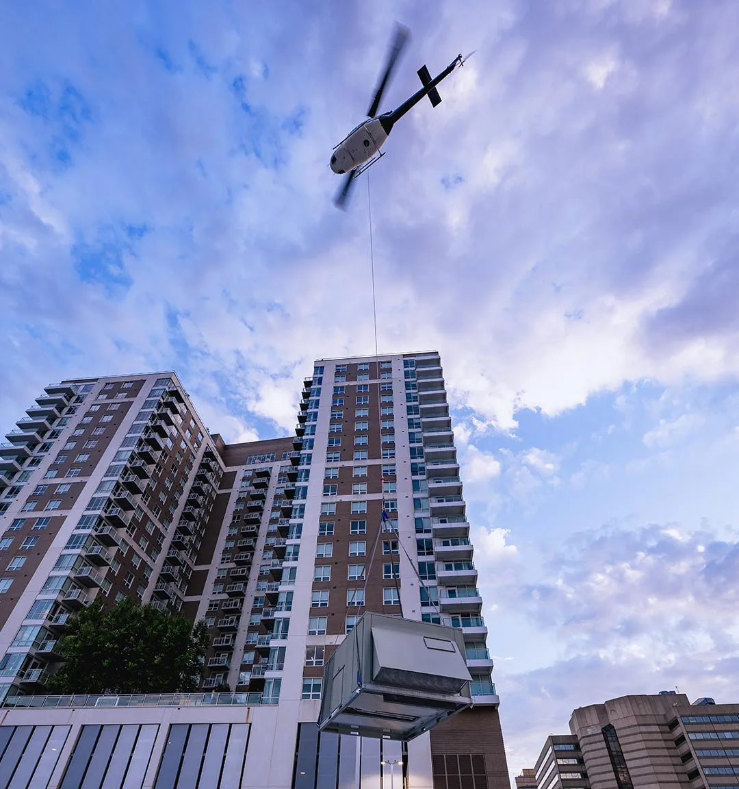 The HVAC unit, mid-lift, on its way to placement. | Photo: Damon Bowe