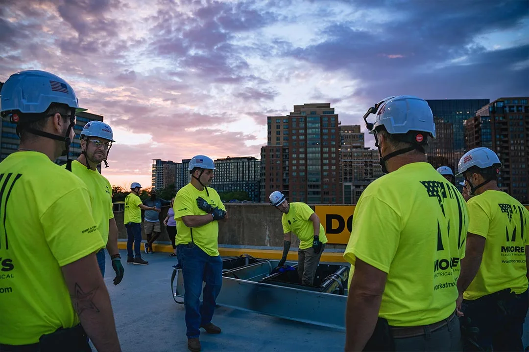 Technicians review strict compliance rules and coordination details during an early morning safety briefing on the deck. | Photo: Damon Bowe