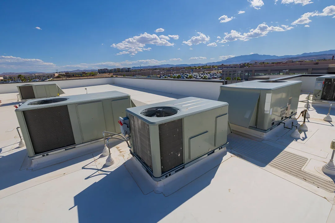 Commercial rooftop with HVAC equipment and surrounding terrain illustrating helicopter lift placement considerations.